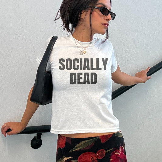person wearing a t-shirt saying "socially dead"